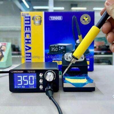 This is a Mechanic T-210 desktop soldering station, featuring an intelligent LED digital display.It includes a compact, all-metal body with a 210 series heating core and a dormant soldering iron seat.The system has a temperature display in Celsius and includes short circuit protection for electronics repair.The package generally contains the soldering station, iron handle, iron tip, and power cable.